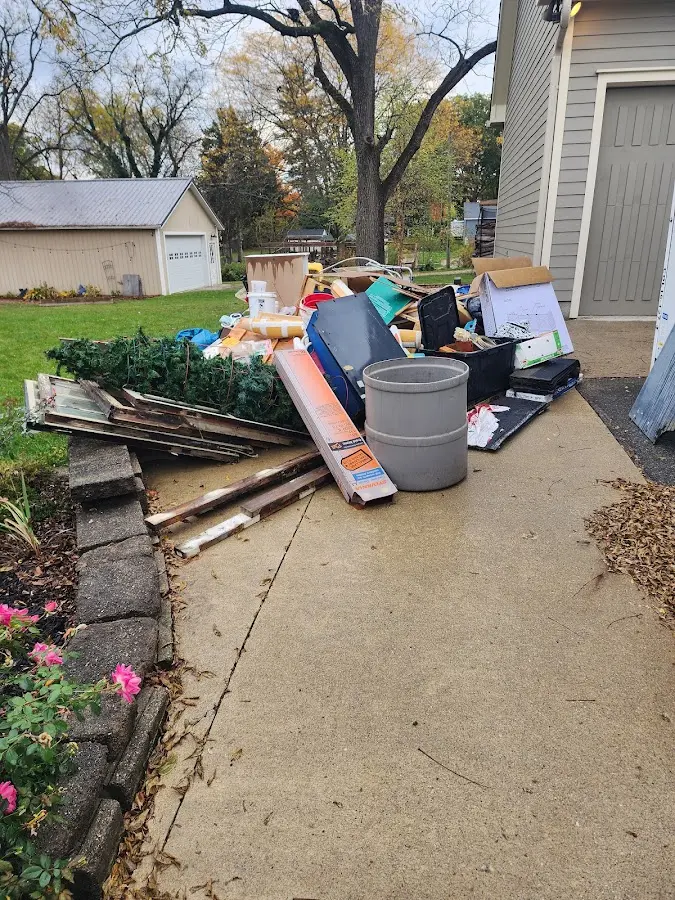 Dumpster being loaded with debris for Roofing Dumpster Rental in Pasadena